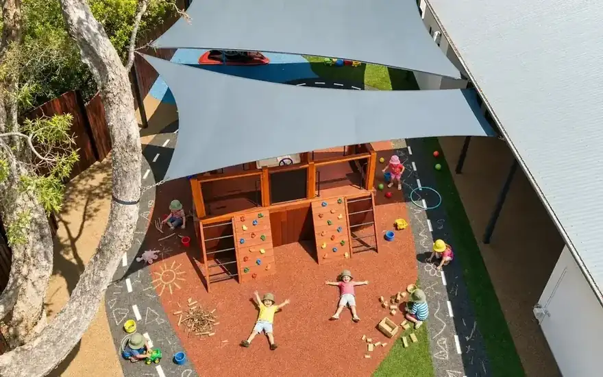 The same play area with children playing among the toys